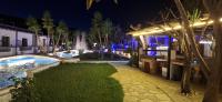 a resort with a pool and a fountain at night at Skiathos Holiday Resort in Skiathos