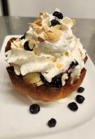 a dessert with whipped cream and berries on a plate at Auberge des 7 Tours in Martel