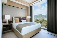 a bedroom with a bed and a large window at Amari Phuket in Patong Beach