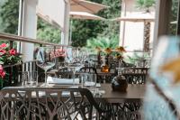 a table with wine glasses on a patio at Exclusive Boutique Hotel Elisabetta in Ronco s/Ascona - Porto Ronco