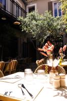 a table with a white table cloth and flowers on it at La Maison Clémenceau in Salon-de-Provence
