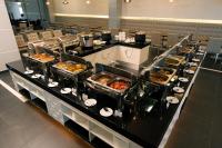 a buffet line with many trays of food at Hotel Tamara Melaka in Melaka