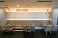 a dining room with tables and chairs and lights at Hotel Tamara Melaka in Melaka