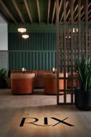 a lobby with couches and a clock on the floor at Ada Hotel in Ada