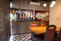 un comedor con una mesa y carteles en la pared en 長峰荘, en Azumino