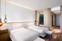 two beds in a room with a window at W Dubai - Mina Seyahi in Dubai