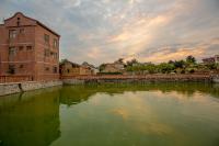 a large body of water next to a brick building at Zhu Shan Grandee B&amp;B in Jincheng