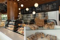 a bakery with many different types of pastries on display at Royal Phuket City Hotel in Phuket Town