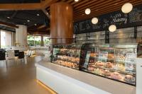 a bakery with a display case filled with pastries at Royal Phuket City Hotel in Phuket Town