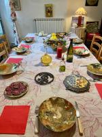 a table with plates and wine glasses on it at Les Asphodeles chambre familiale Lilah in Saint-Hippolyte-du-Fort