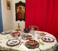 a table with plates of food and a red curtain at Les Asphodeles chambre familiale Lilah in Saint-Hippolyte-du-Fort