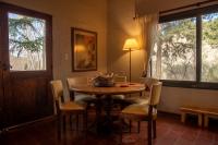 a dining room with a wooden table and chairs at San Ignacio Estancia Andina in El Challao