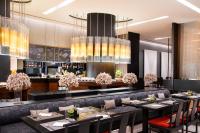 a dining room with tables and chairs and chandeliers at Le Meridien Chiang Rai Resort, Thailand in Chiang Rai