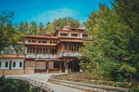 a large building with trees in front of it at Hotel Bozhentsi in Chernevtsi