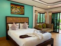 a bedroom with a large white bed and a couch at Koh Chang Bailan Beach Resort in Ko Chang