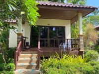 a villa with a porch with chairs on it at Koh Chang Bailan Beach Resort in Ko Chang