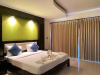 a bedroom with a bed with a flower on it at Koh Chang Bailan Beach Resort in Ko Chang