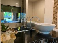 a bathroom with a sink and a mirror at Koh Chang Bailan Beach Resort in Ko Chang
