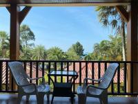 two chairs and a table on a balcony at Koh Chang Bailan Beach Resort in Ko Chang