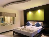 a bedroom with a large bed with a green wall at Koh Chang Bailan Beach Resort in Ko Chang