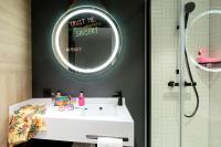 a bathroom with a white sink and a mirror at Moxy The Hague in The Hague
