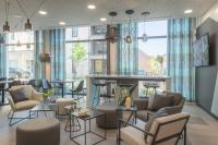 Un vestíbulo con un bar con sillas y mesas. en Holiday Inn - the niu, Seven Dusseldorf Ost by IHG, en Düsseldorf