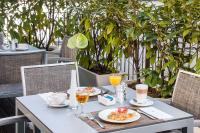 a table with food and drinks on a patio at NH Frankfurt Messe in Frankfurt