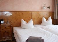 two beds with white pillows in a hotel room at Pensionszimmer Unicat in Potsdam
