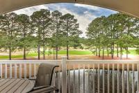 einen Balkon mit Blick auf einen Golfplatz durch ein Fenster in der Unterkunft Beautiful 1500 s f 3 Bd - 2 Ba condo overlooking stream and golf course in Myrtle Beach