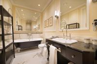 a bathroom with two sinks and a bath tub at Wilson Palace by LOFT in Bratislava