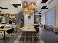 a dining room with tables and chairs and lights at Campanile Shanghai Oriental Beauty Valley Avenue Xianpu Road in Fengxian