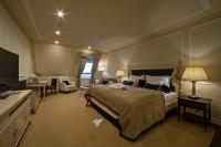 a bedroom with a large bed and a living room at Wilson Palace by LOFT in Bratislava
