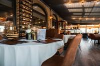 a dining room with two tables and chairs and aearcher at Luxe chalet in Harderwijk