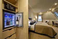 a bedroom with a bed and a tv in a room at Wilson Palace by LOFT in Bratislava