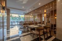 a restaurant with wooden walls and tables and chairs at Awen Lara Hotel in Antalya