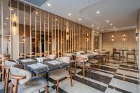 a restaurant with tables and chairs in a room at Awen Lara Hotel in Antalya