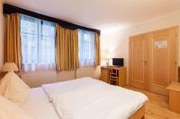 Postel nebo postele na pokoji v ubytování Hotel Maltezský Kříž