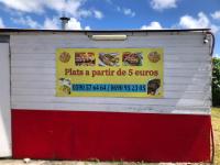 a white and red building with a sign on it at Studio à la campagne in Le Moule