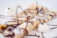 two pastries with chocolate and whipped cream on a table at Hotel Continental Centre-Ville in Val-dʼOr