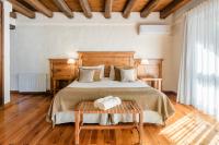 a bedroom with a bed and a table with towels on it at Lares De Chacras in Chacras de Coria