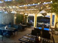 um restaurante com mesas, cadeiras e luzes em Stonerock Lodge em Chepstow