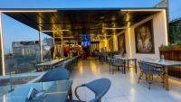 a restaurant with tables and chairs on a balcony at Giza Pyramids View Inn in Cairo