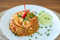 a white plate of food with shrimp and rice at Reboot Retreat Beach Resort, Restaurant, and Coffee Shop in Ban Talat Bang San