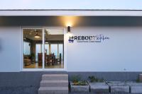 a white building with a window and a dining room at Reboot Retreat Beach Resort, Restaurant, and Coffee Shop in Ban Talat Bang San