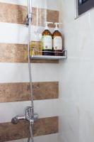 a shelf above a sink in a bathroom at Wei Sen House in Hualien City