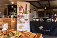 a table with a bunch of bottles of wine and bread at Pabala Private Nature Reserve in Hankey