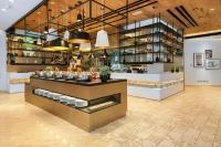 a restaurant with a counter with dishes in it at Fujairah Rotana Resort & Spa - Al Aqah Beach in Al Aqah