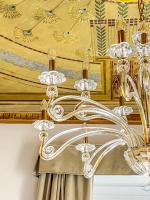 a chandelier hanging from a ceiling in a room at Hotel Genova Liberty in Genoa