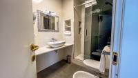 a bathroom with a sink and a toilet at Hotel Genova Liberty in Genoa