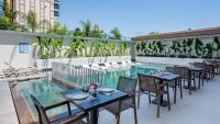 a patio with tables and chairs next to a swimming pool at Awen Lara Hotel in Antalya